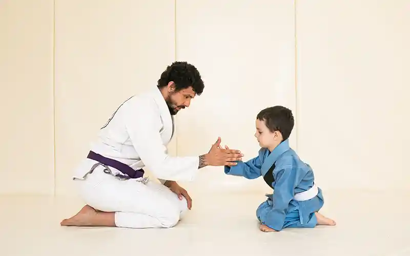 adule and child practicing martial arts