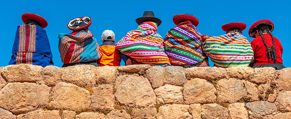 Colorful Image of the Backs of Quechia Women in Indigenous Dress